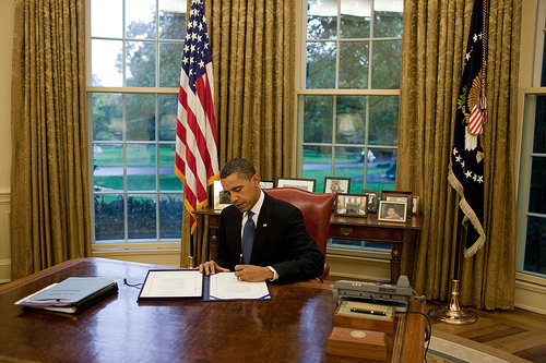 President Barack Obama signs the Enhanced Partnership with Pakistan Act of 2009, also known as 'Kerry-Lugar-Berman' in the Oval Office, Oct. 15, 2009. (Official White House Photo by Chuck Kennedy) 